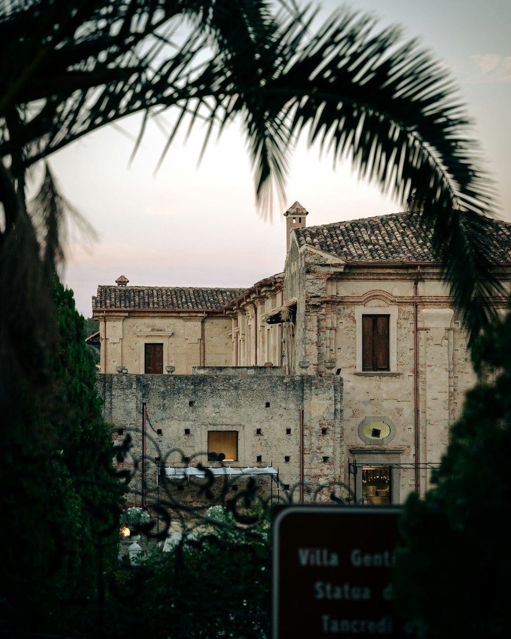 a building with a palm tree in front of it