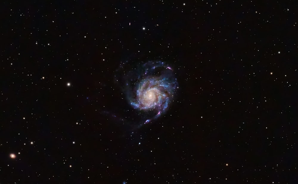 a spiral galaxy in the middle of the night sky