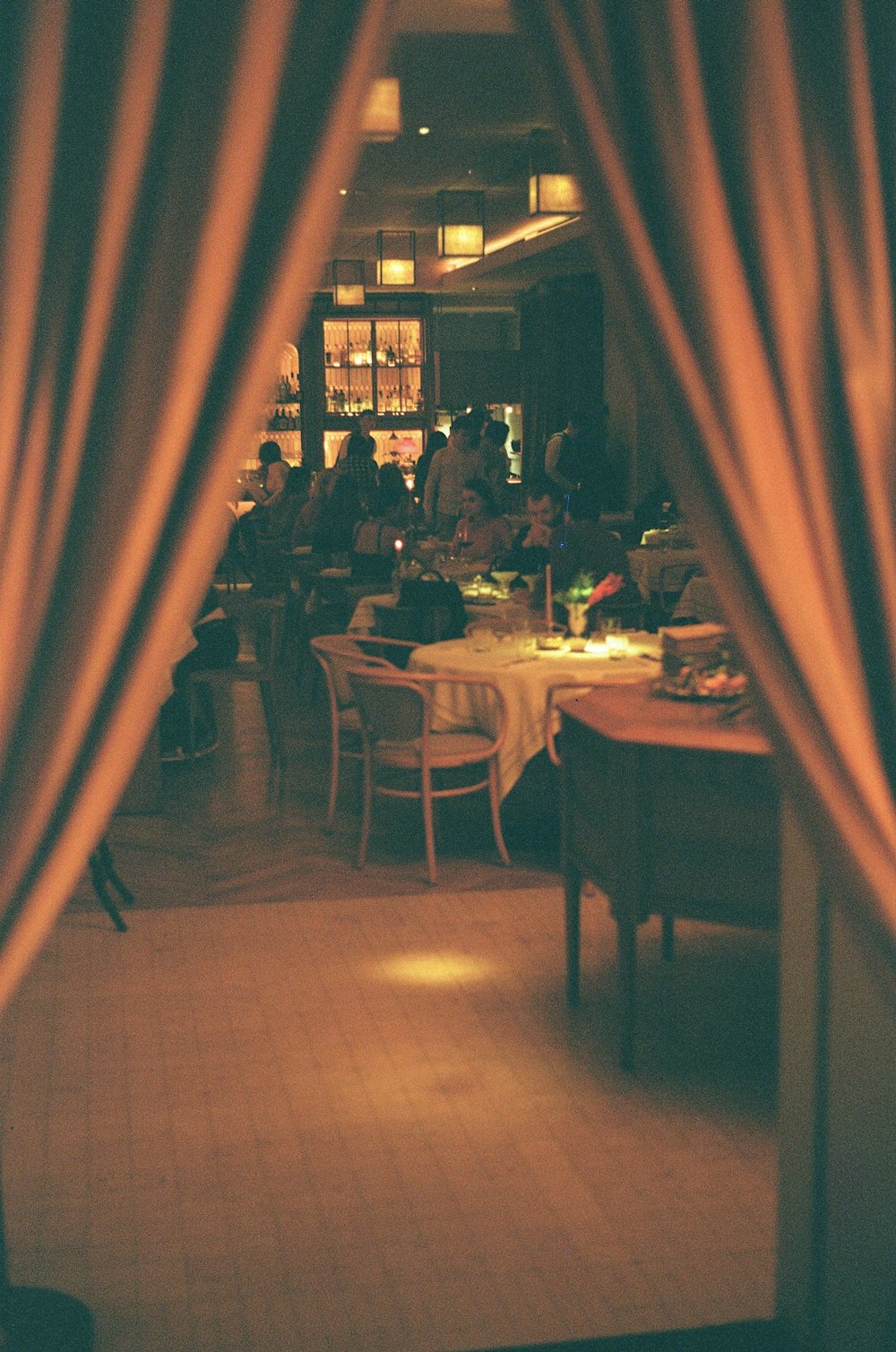 a group of people sitting at a table in a restaurant