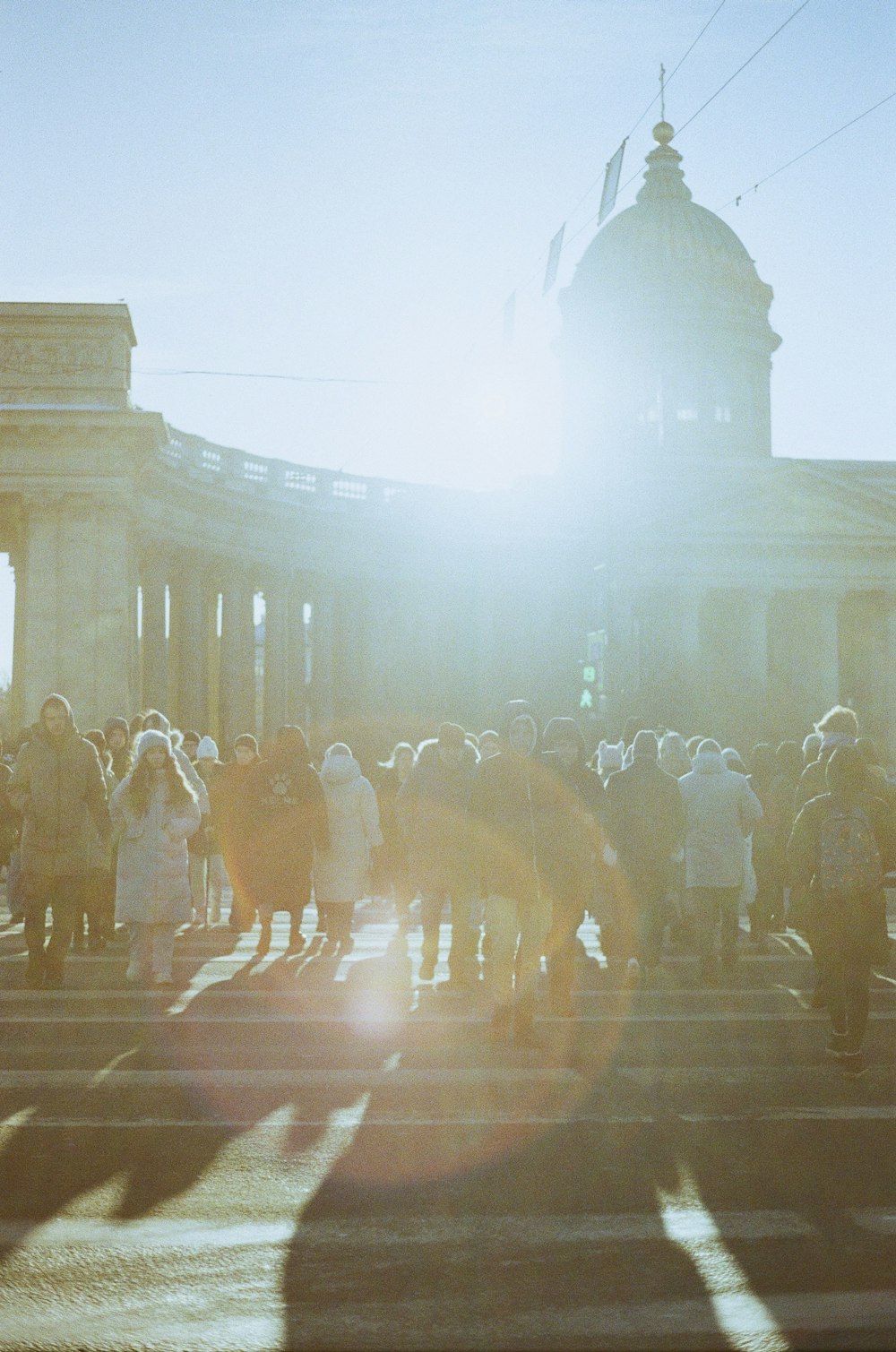 a group of people standing on a street next to a building