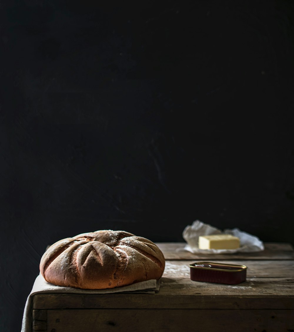 a loaf of bread sitting on top of a wooden table