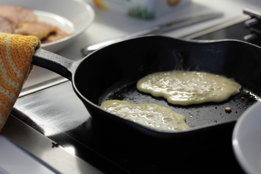 a frying pan filled with food on top of a stove