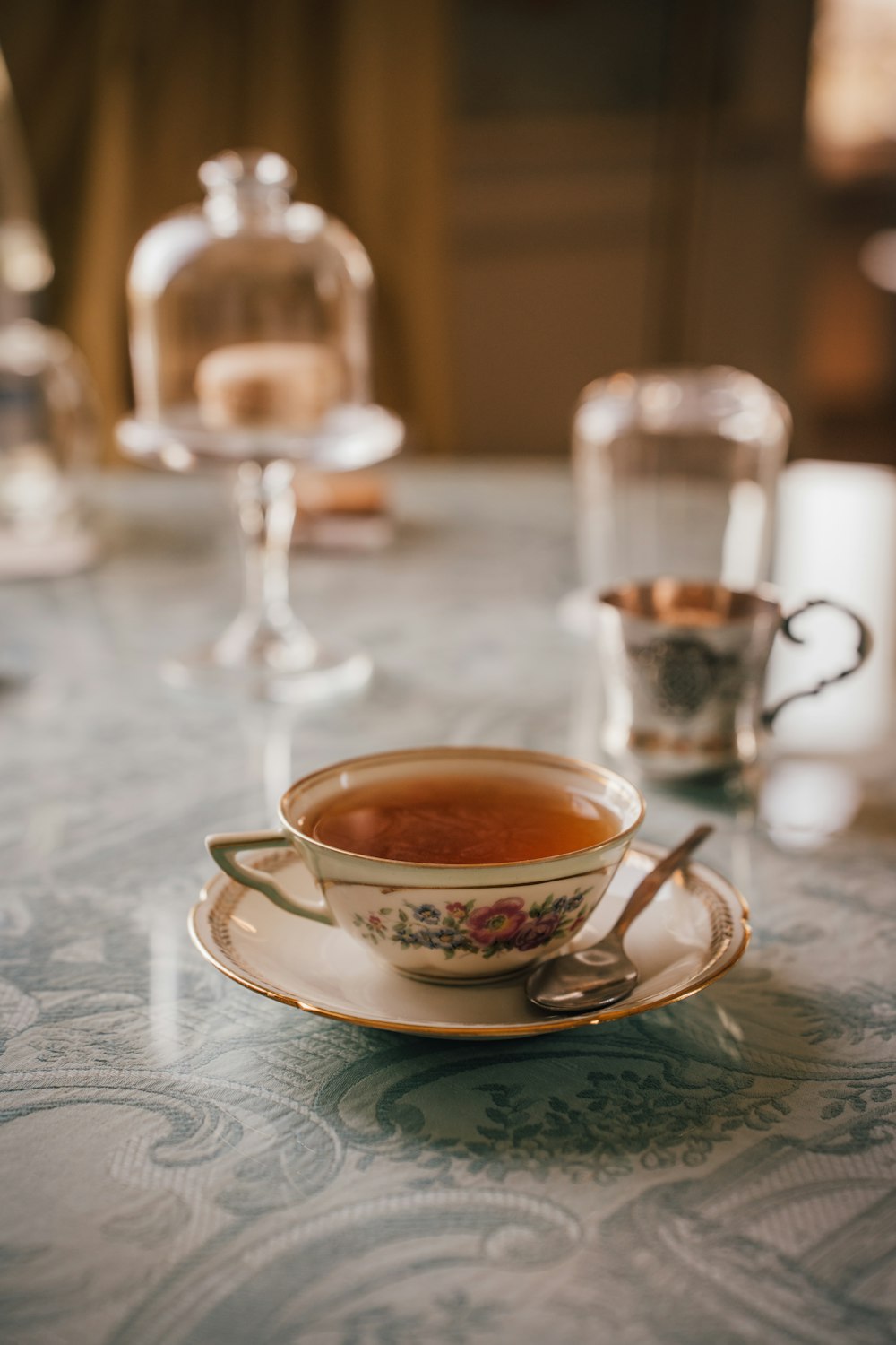 a cup of tea on a saucer on a table