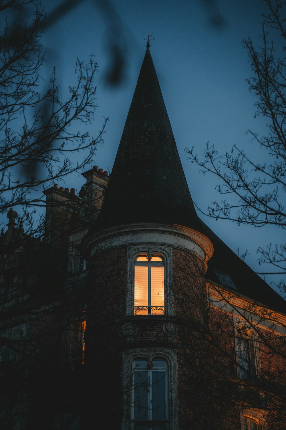 a building with a tower with a lit up window