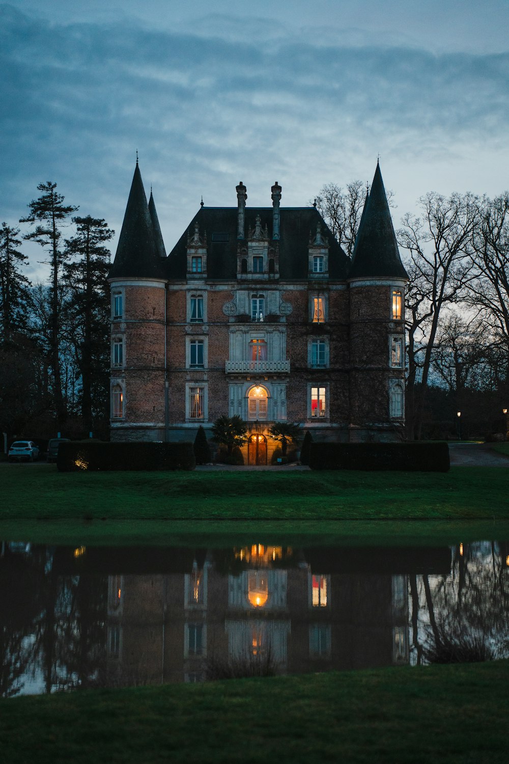 a large building with a lot of windows next to a body of water