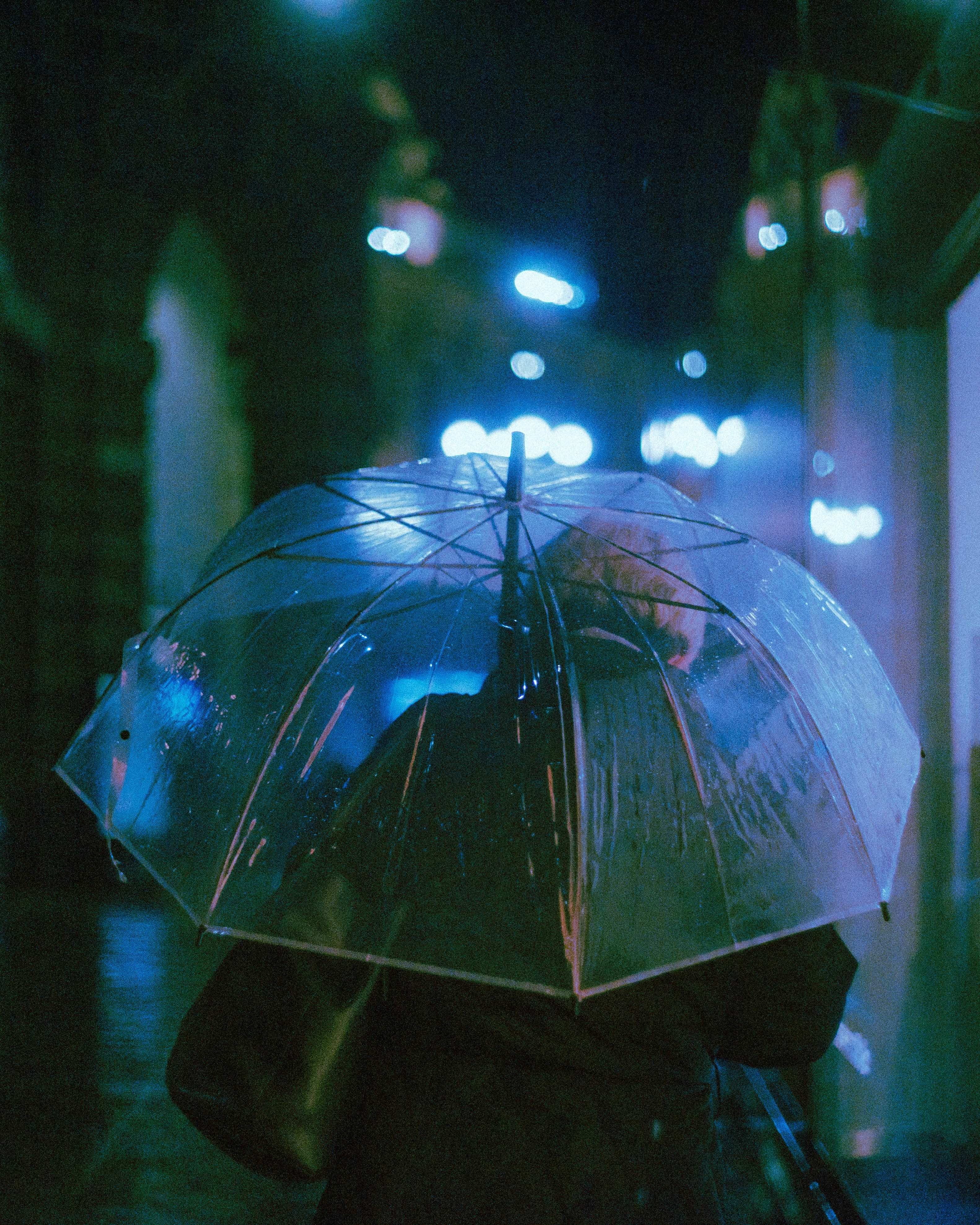 a person walking down a street holding an umbrella