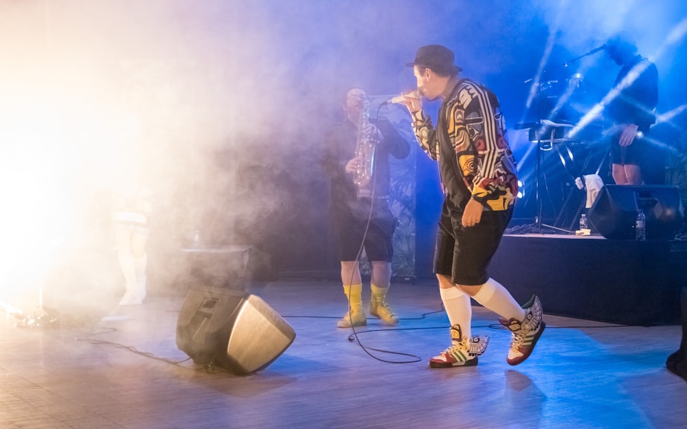 a group of men standing on top of a stage