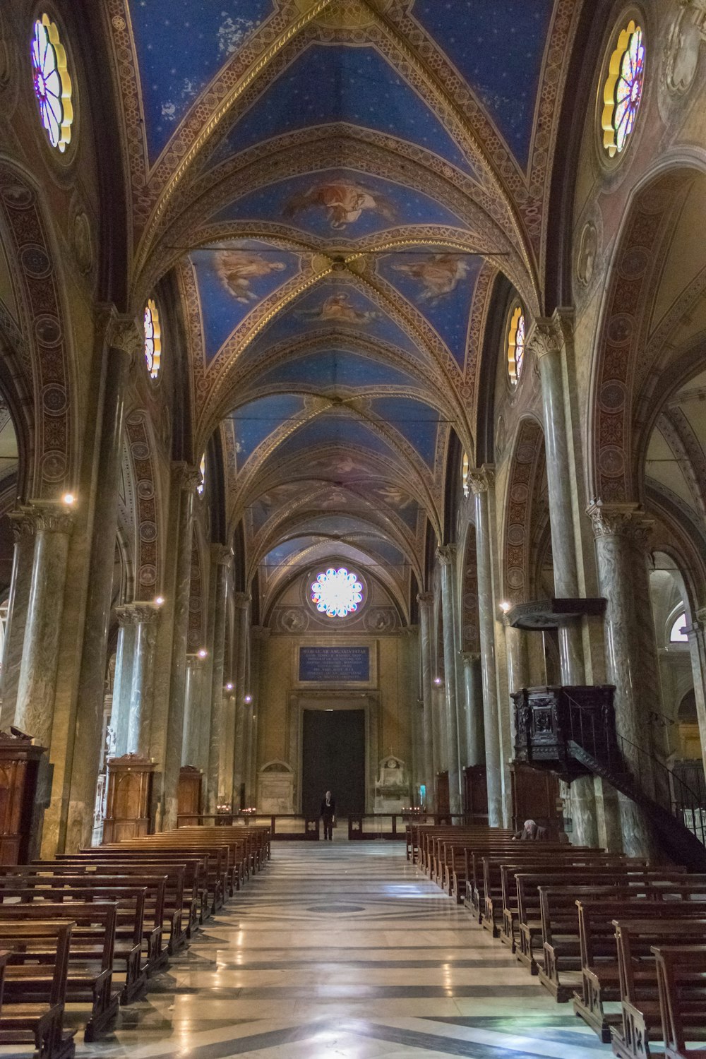 a church with a vaulted ceiling and stained glass windows