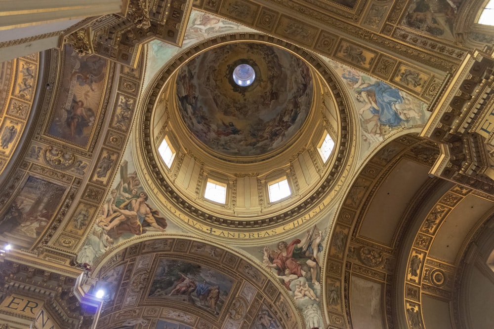 the ceiling of a church with paintings on it