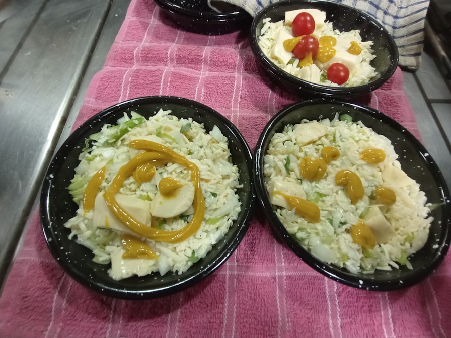 a table topped with black plates filled with food