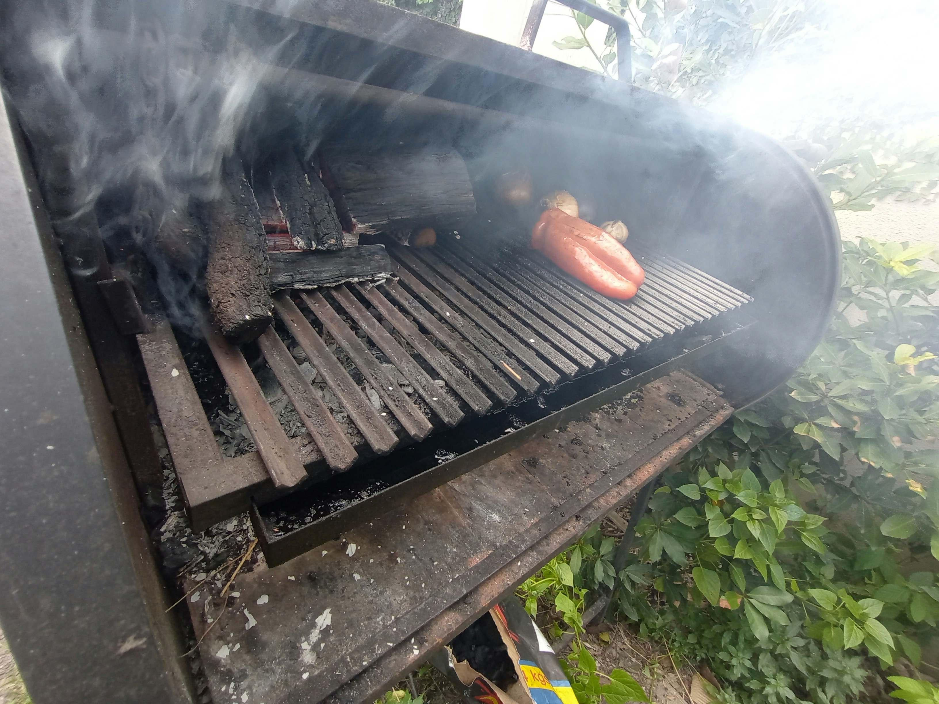 a hot dog is being cooked on a grill