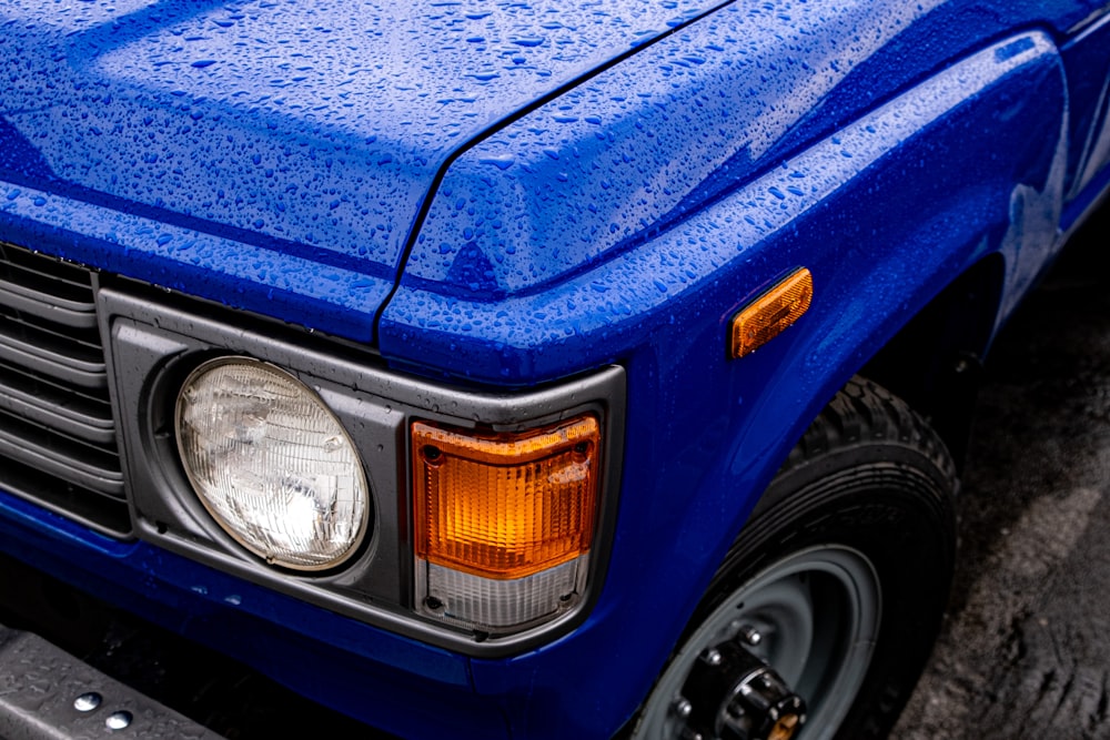 a blue pick up truck parked on the side of the road