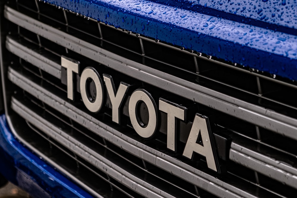 a close up of the front grille of a blue toyota truck