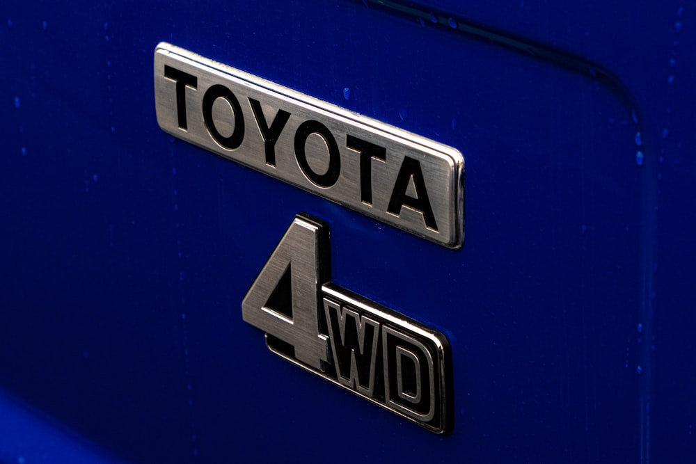 a close up of a toyota logo on a blue car