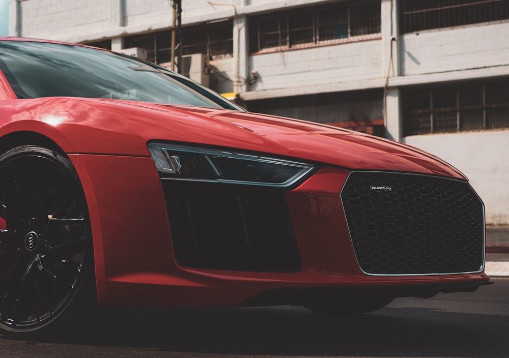 a red sports car parked on the side of the road