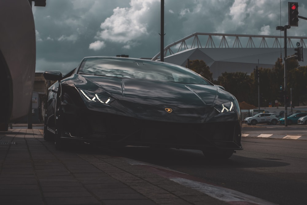 a black sports car parked on the side of the road