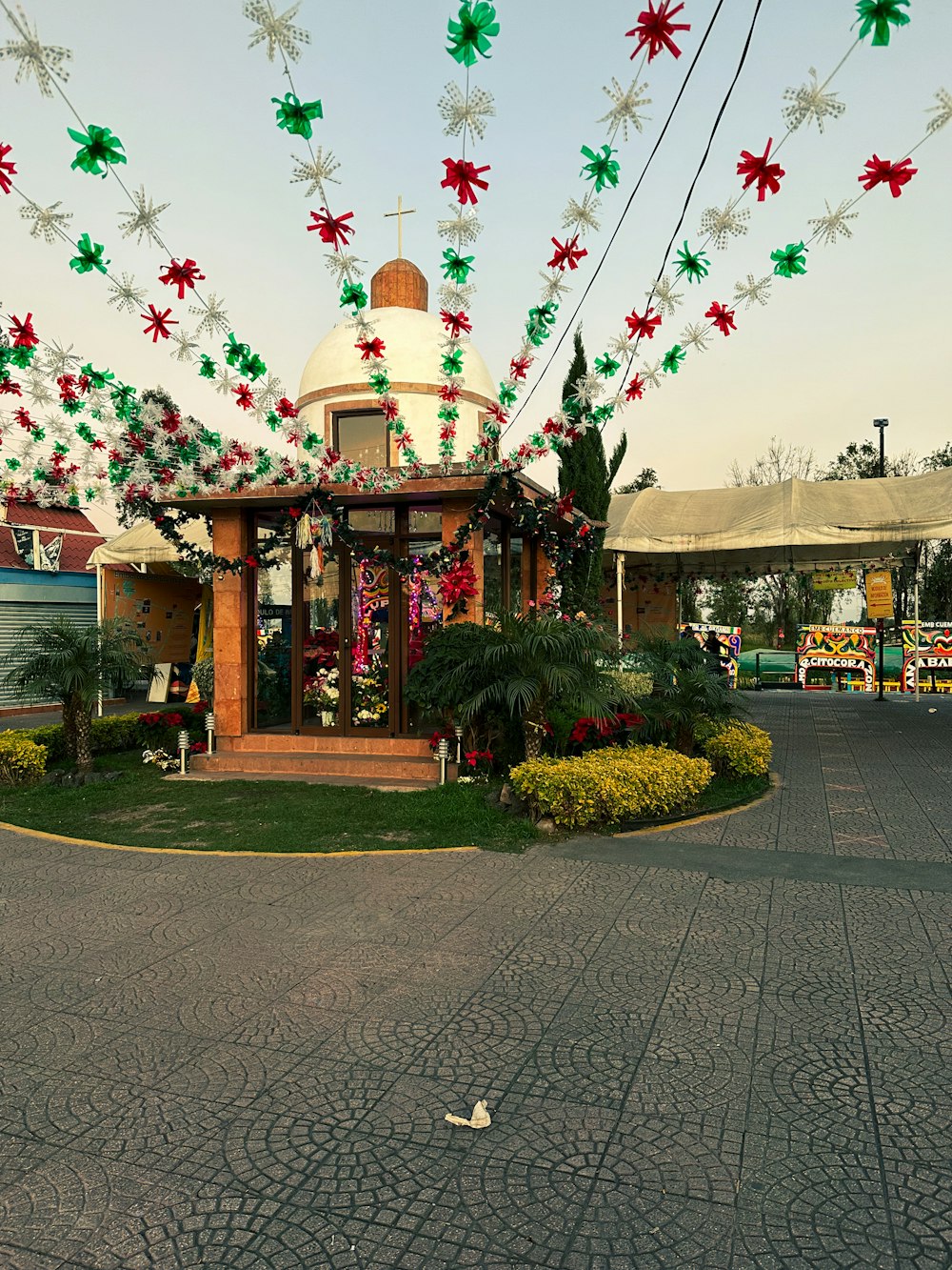 a gazebo with christmas decorations hanging from it's roof