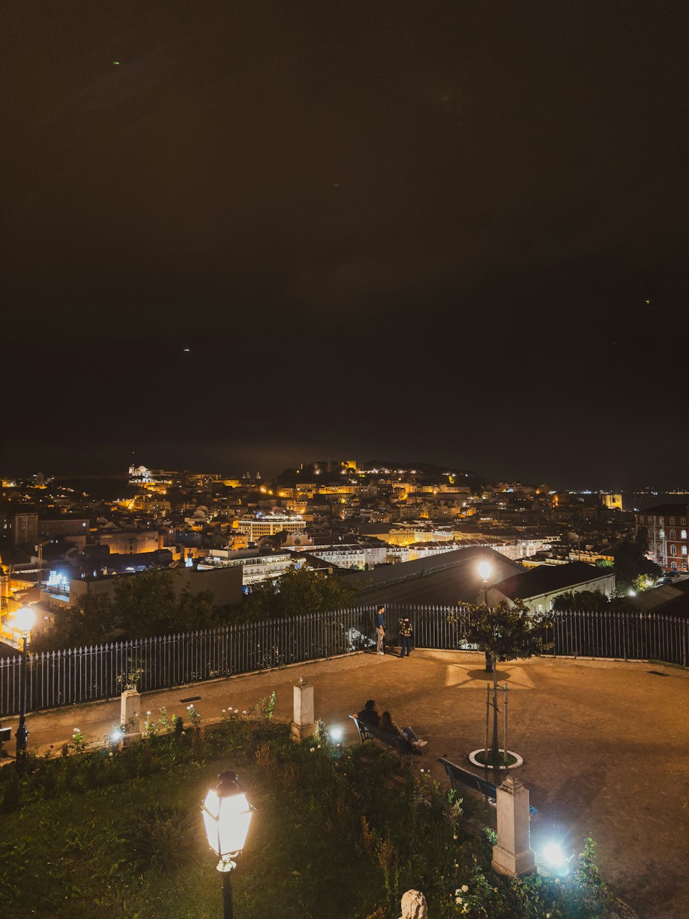 a view of a city at night from a hill