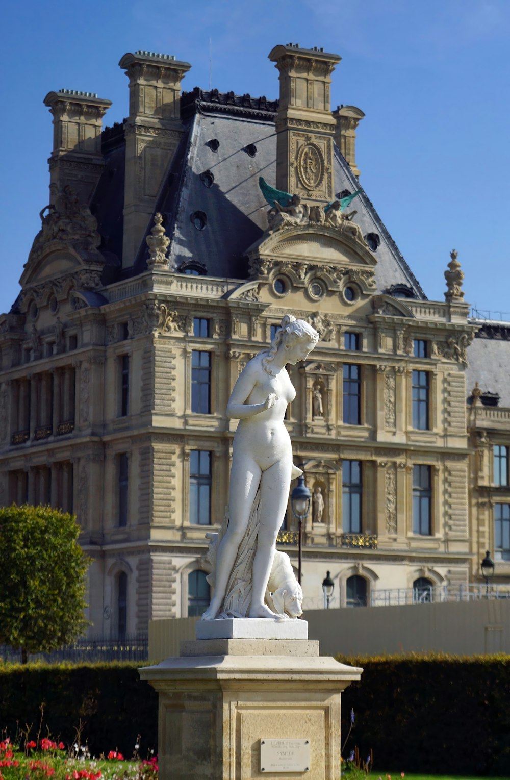 a statue in front of a large building