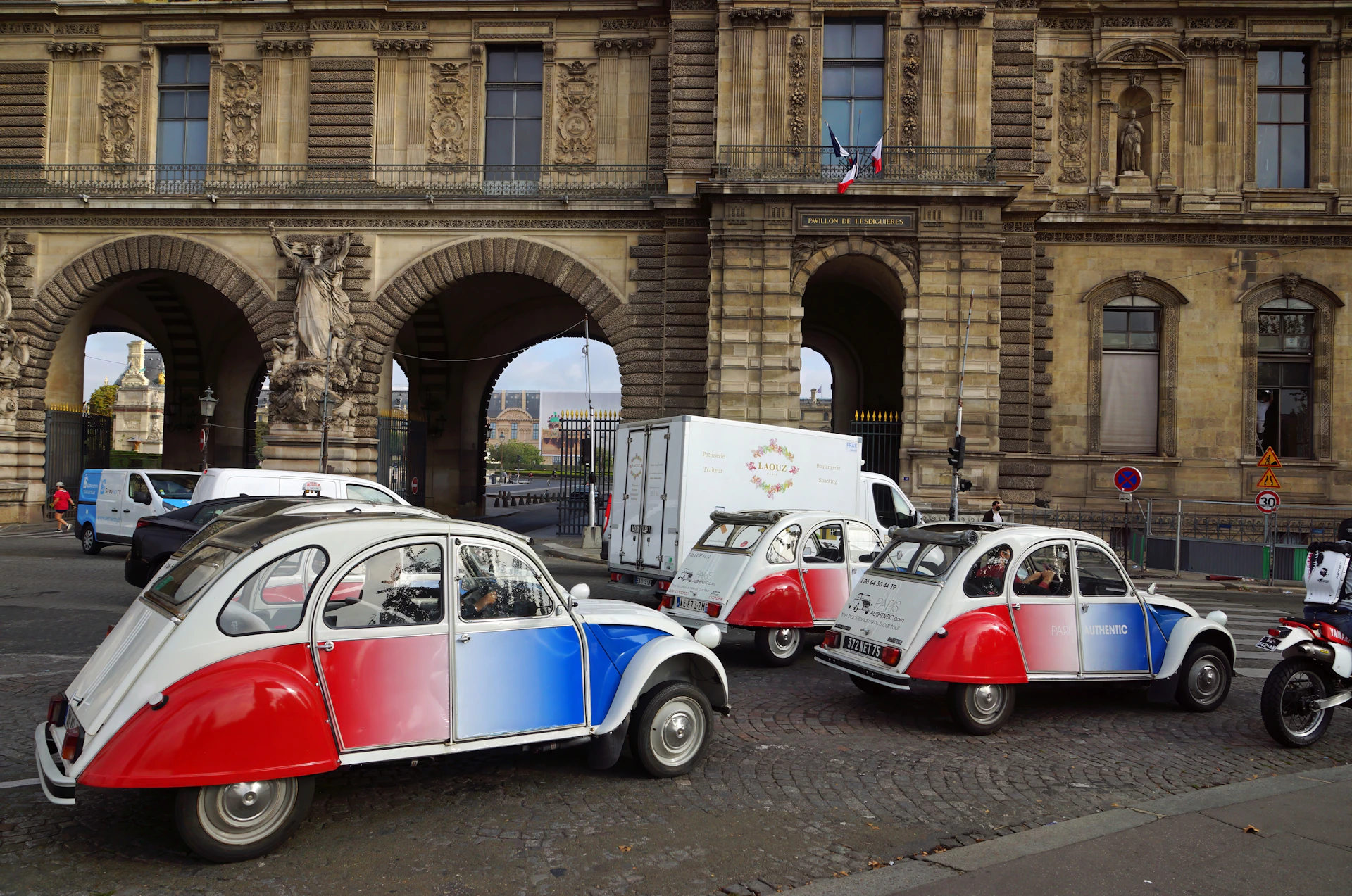 a couple of small cars parked in front of a building