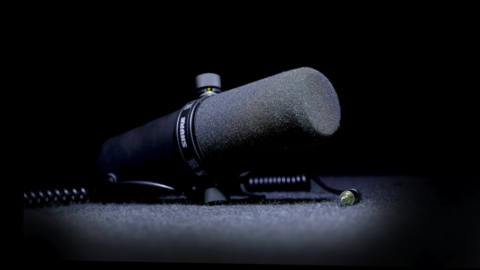 a microphone on the ground with a black background