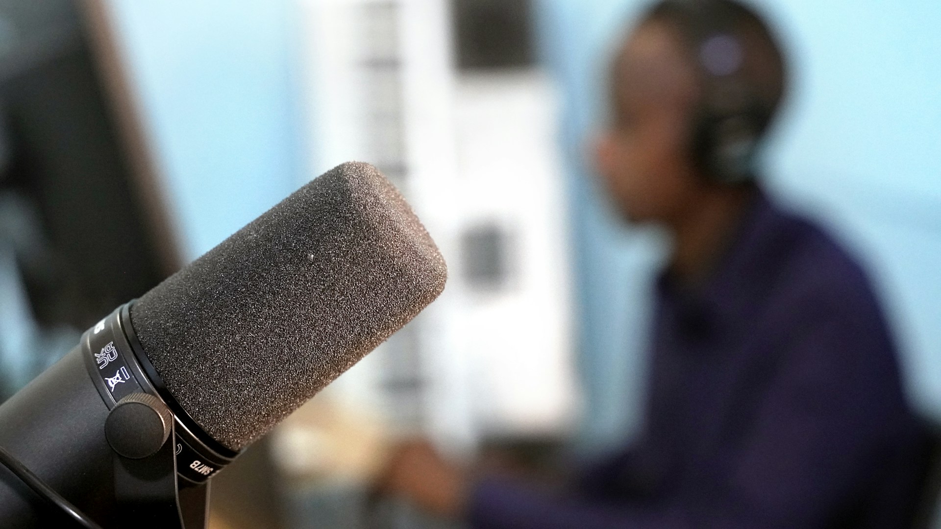 a man sitting in front of a microphone