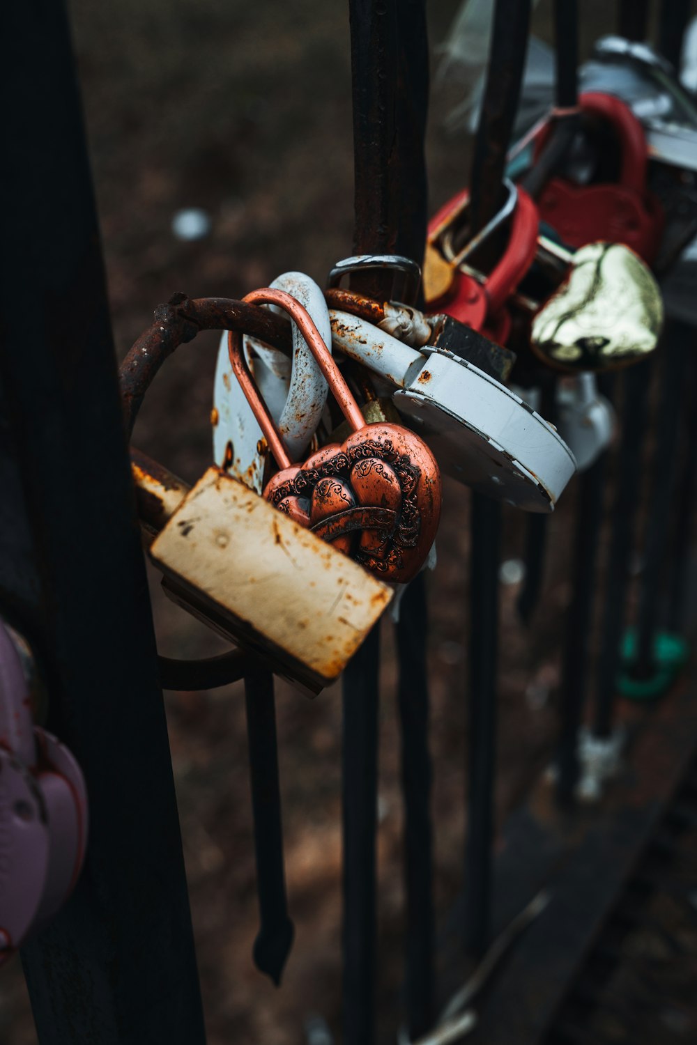 a bunch of locks attached to a fence