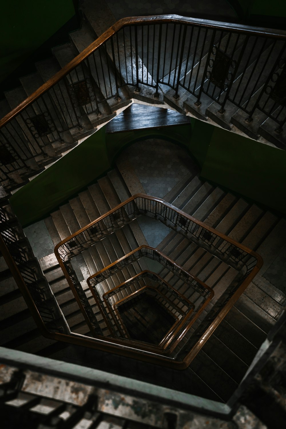 a spiral staircase in a building with metal railings