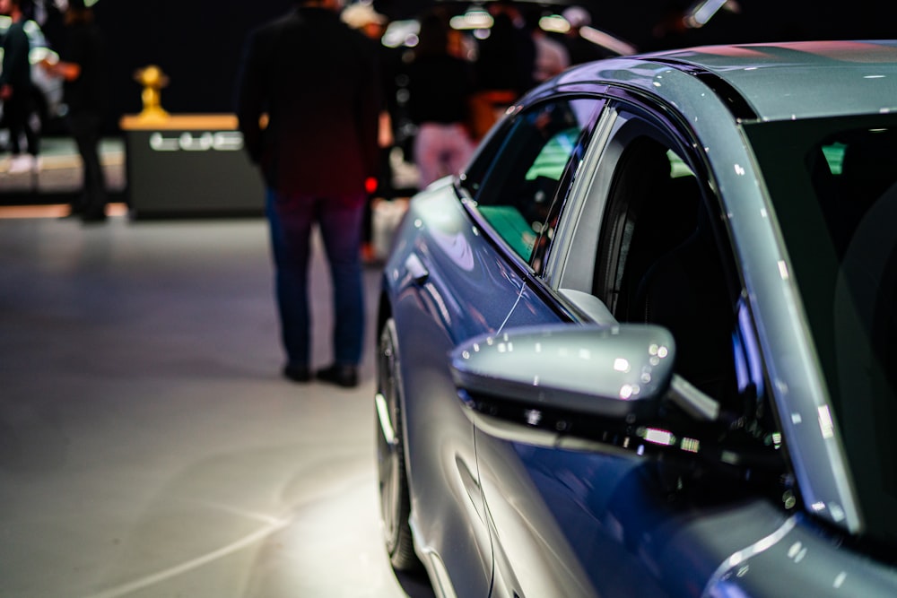 a close up of a car on display at a car show