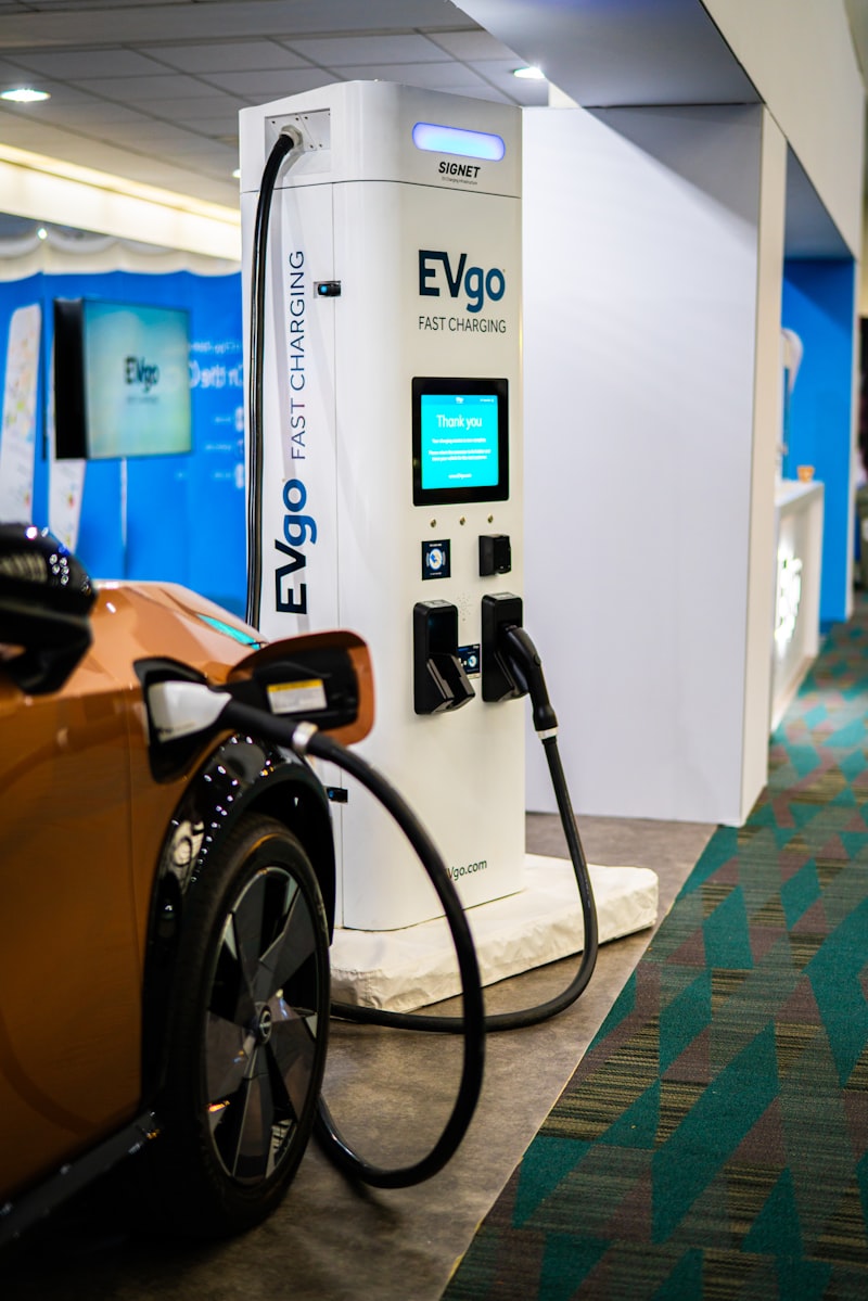 Close up of a charging connector near an electric car
