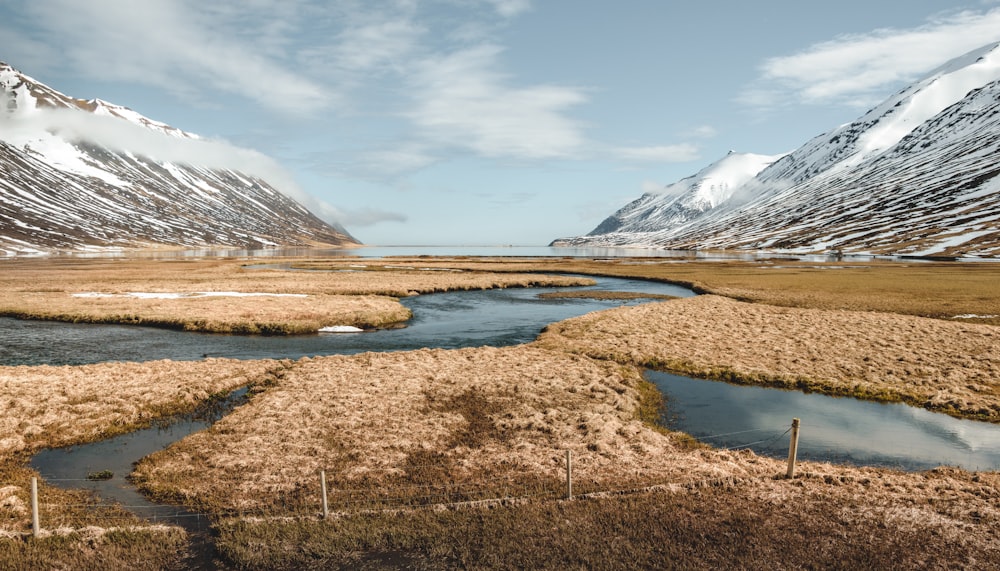 a river running through a grass covered field