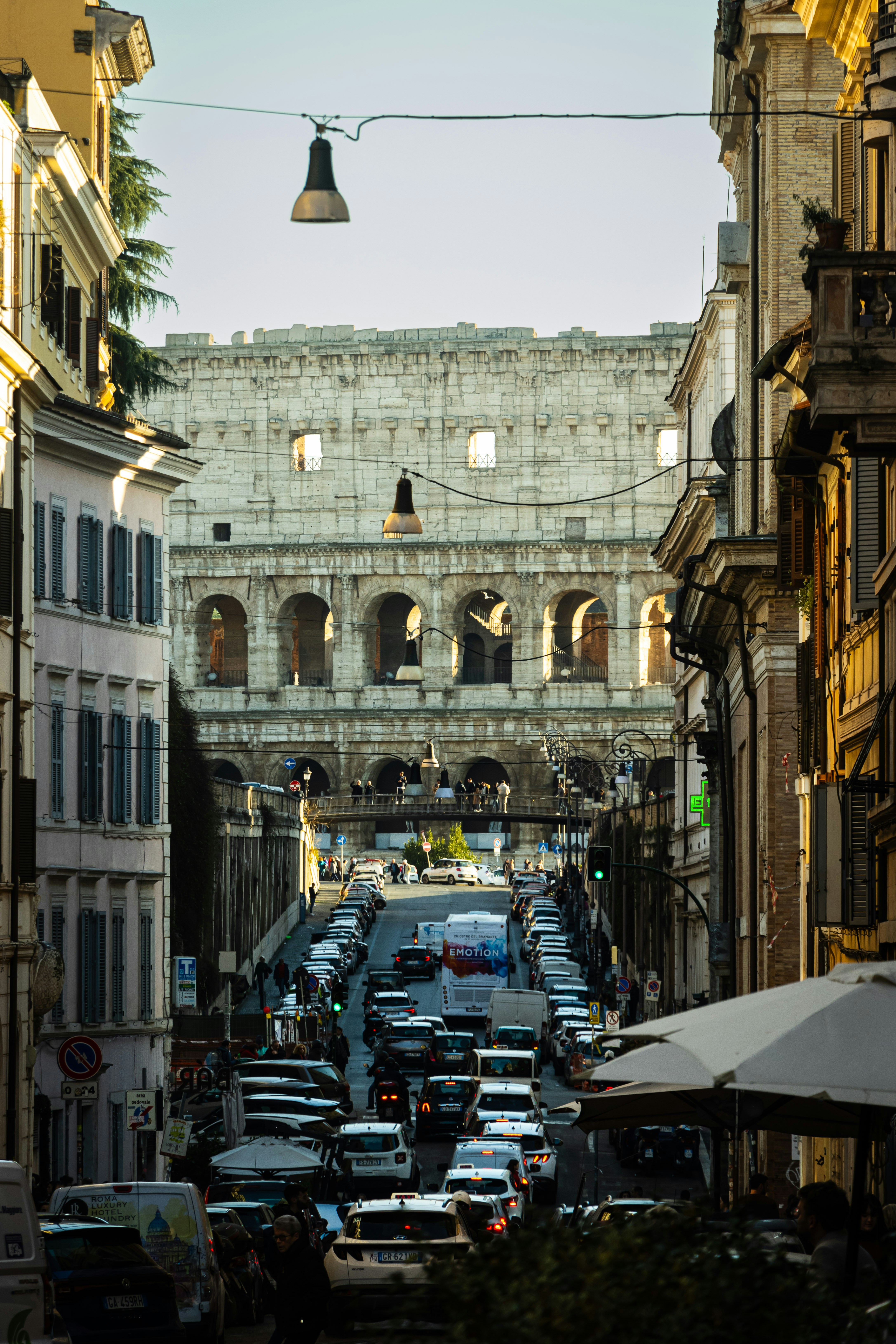 a city street filled with lots of traffic next to tall buildings