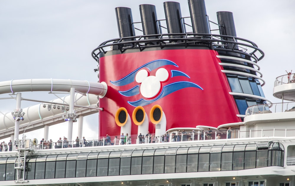 a large red and white boat with people on top of it