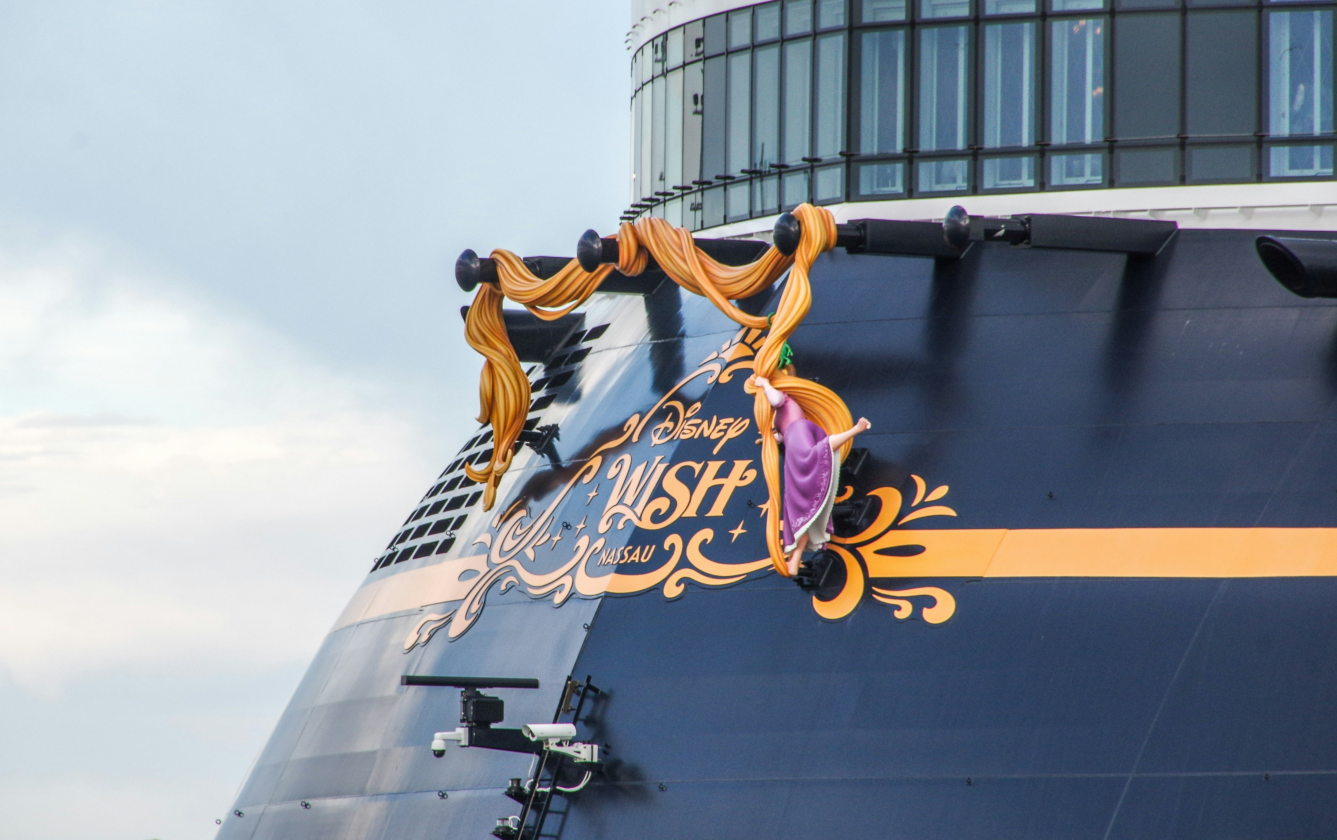 a large cruise ship with a sign on the side of it, The Disney "Wish" cruise ship at Port Canaveral, Florida, January 2024.