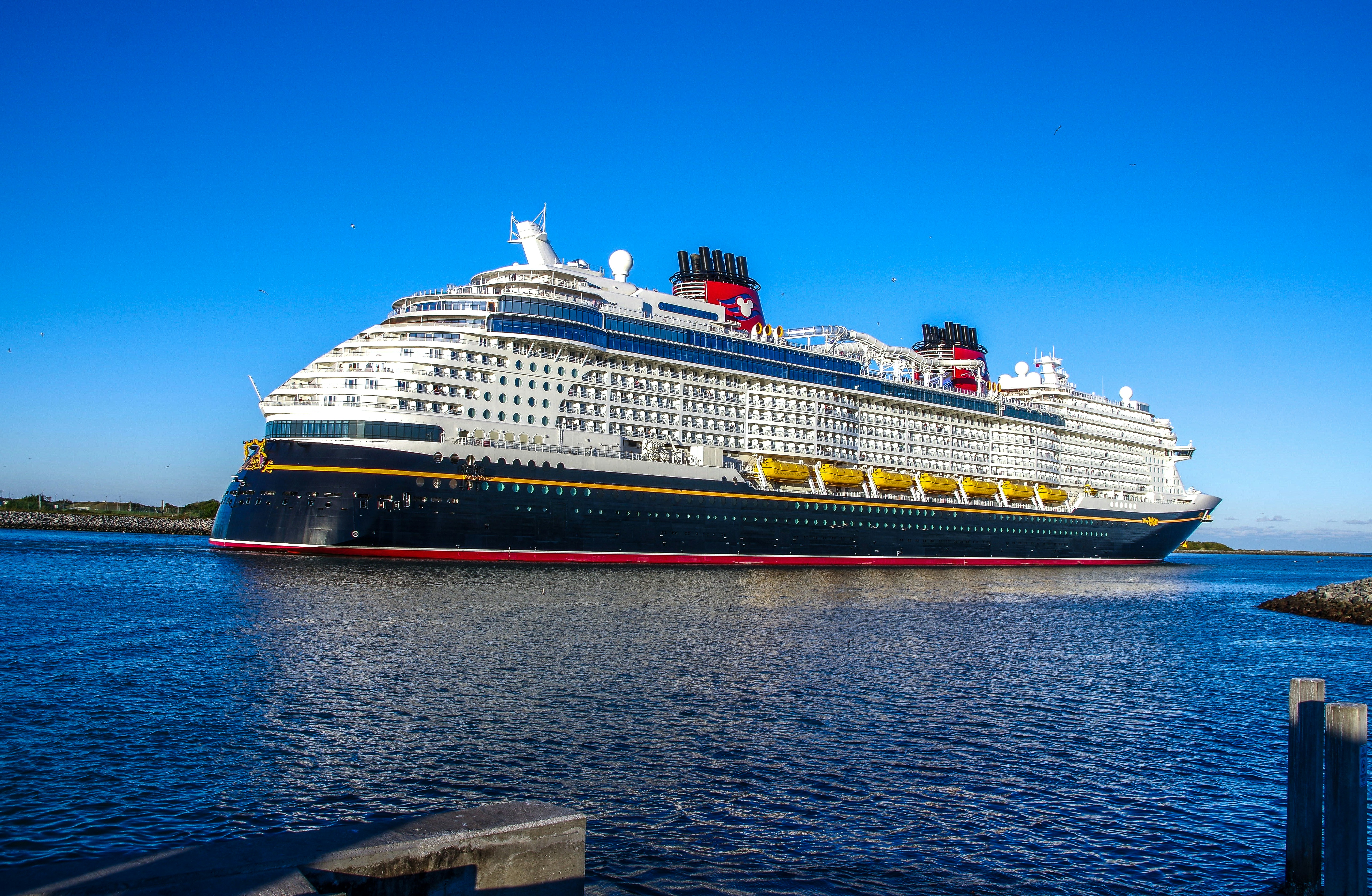a large cruise ship in a body of water, The Disney "Wish" cruise ship at Port Canaveral, Florida, January 2024.