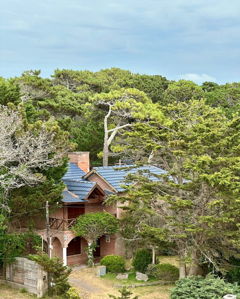 an aerial view of a house surrounded by trees