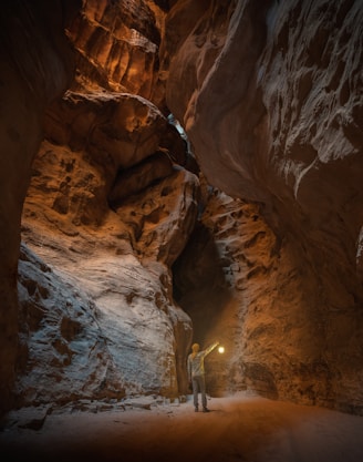 a man standing in a narrow tunnel in a mountain