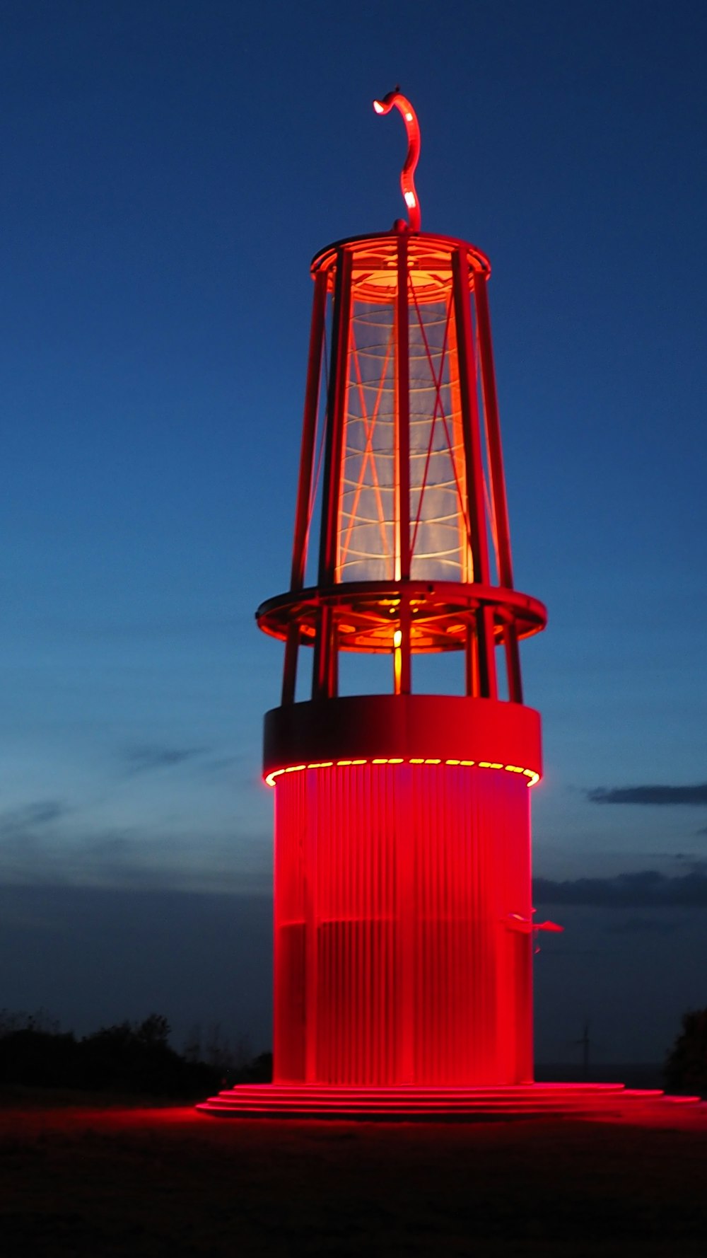 a red light tower lit up at night