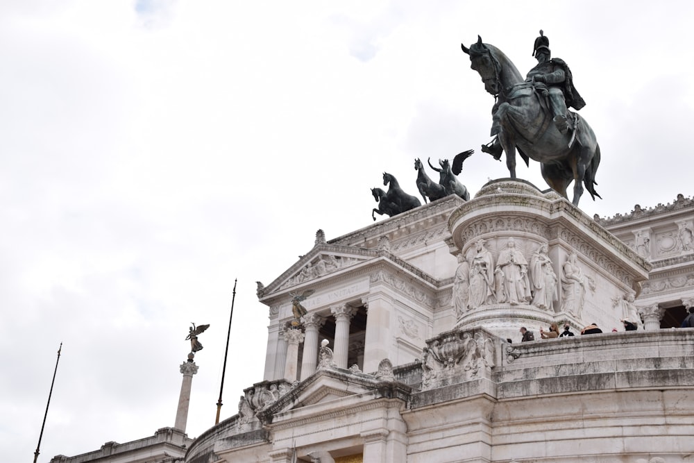 a statue of a man on a horse in front of a building