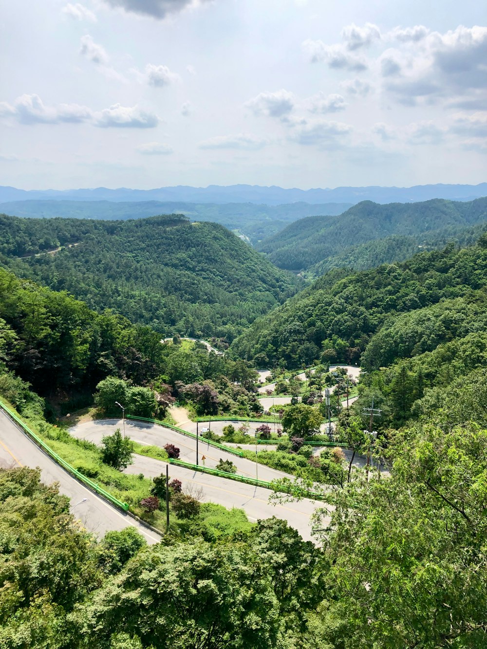 a scenic view of a winding road in the mountains