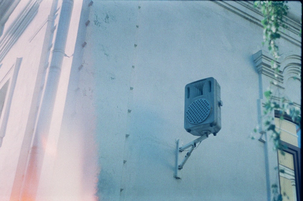 a traffic light attached to the side of a building