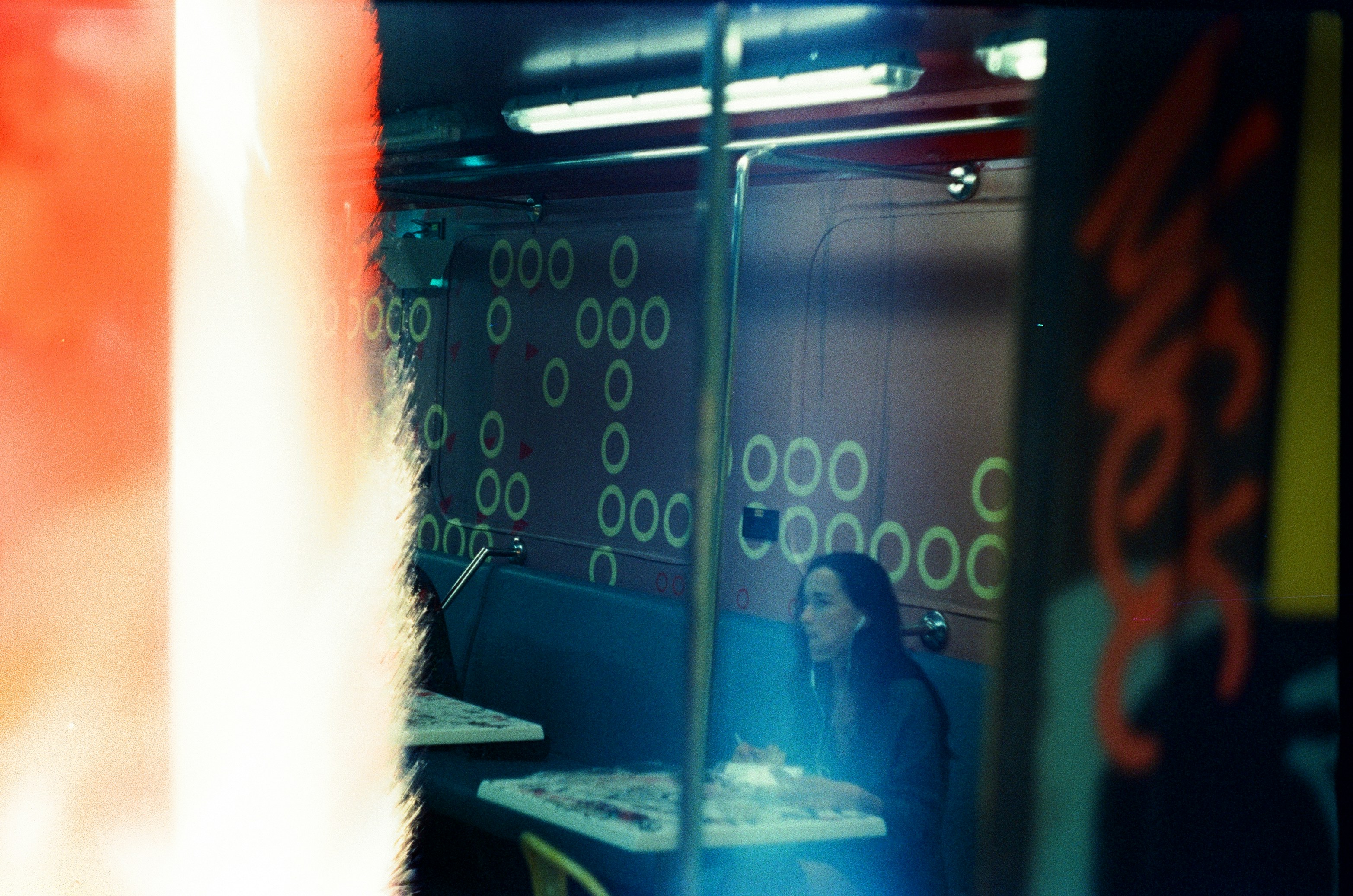 a woman sitting at a table in a restaurant