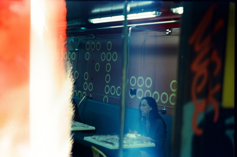 a woman sitting at a table in a restaurant