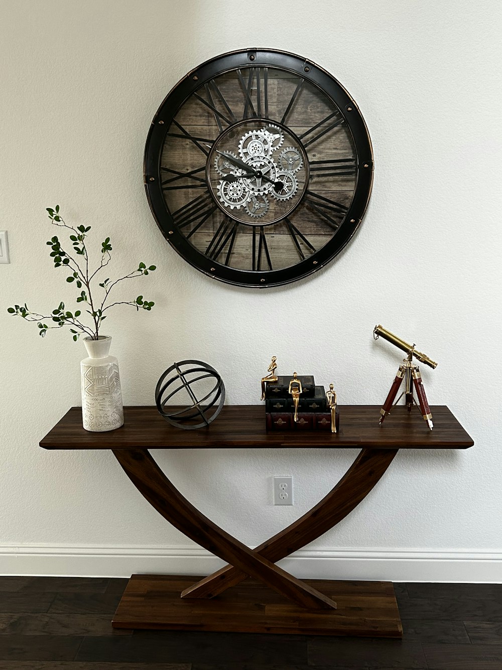 a wooden table with a clock on the wall