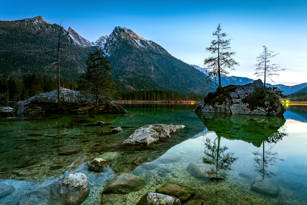 a body of water surrounded by mountains and trees