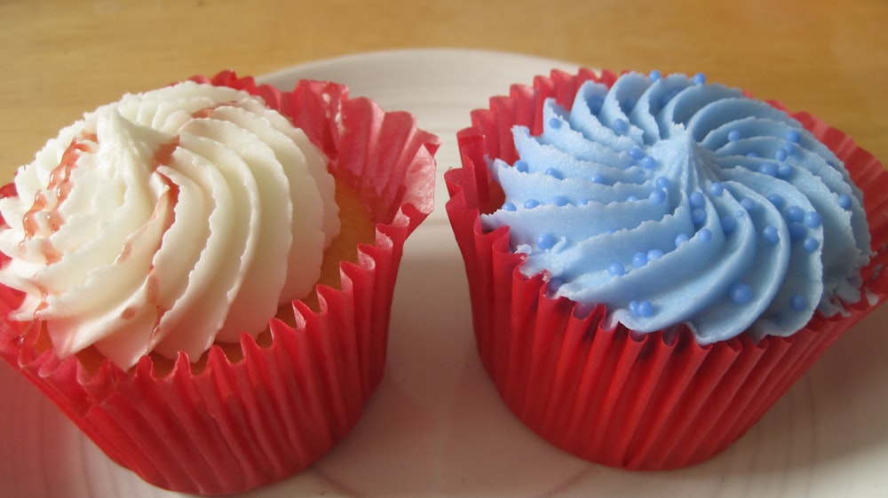 two red, white and blue cupcakes on a plate
