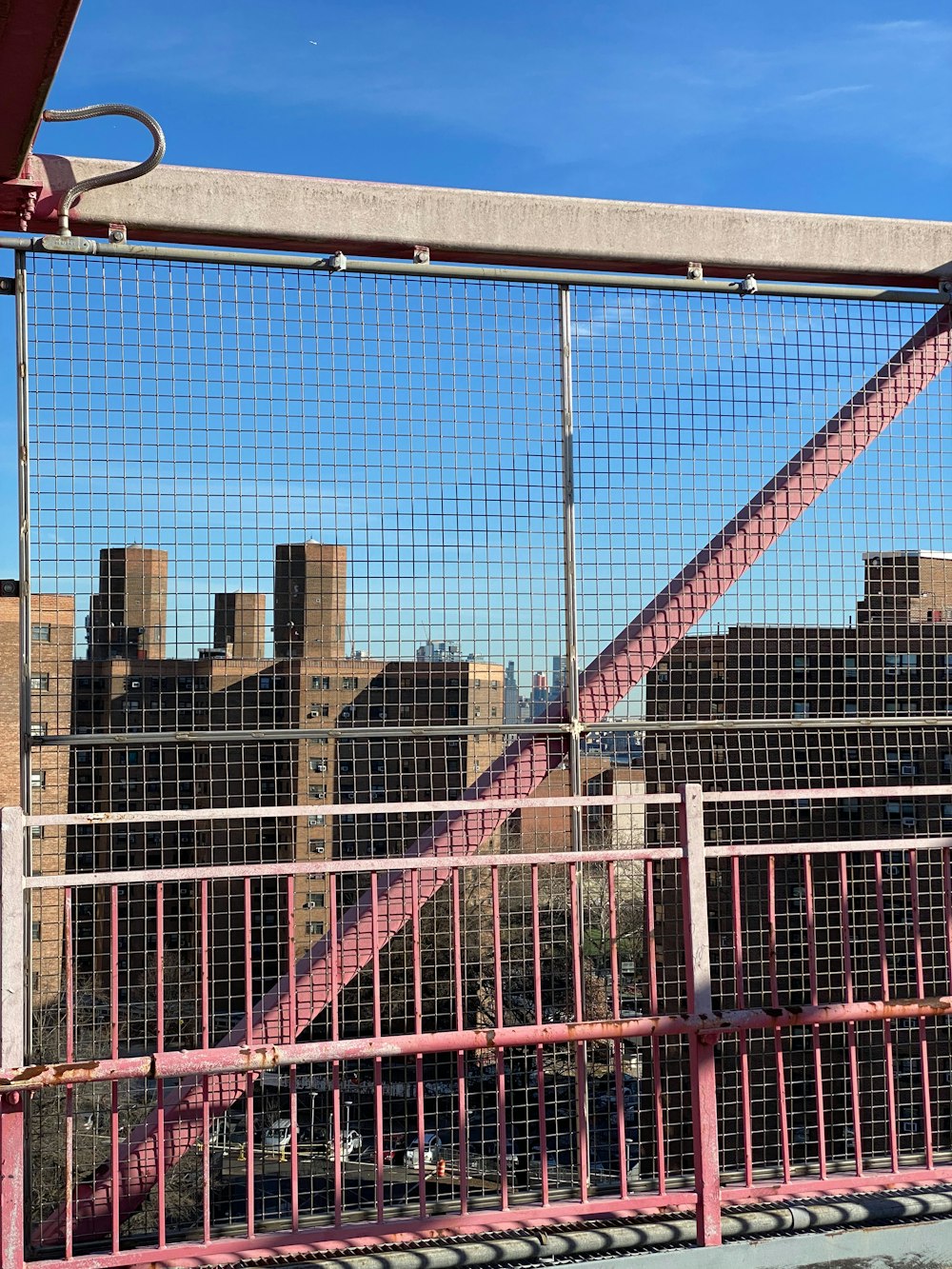 a view of a city through a fence