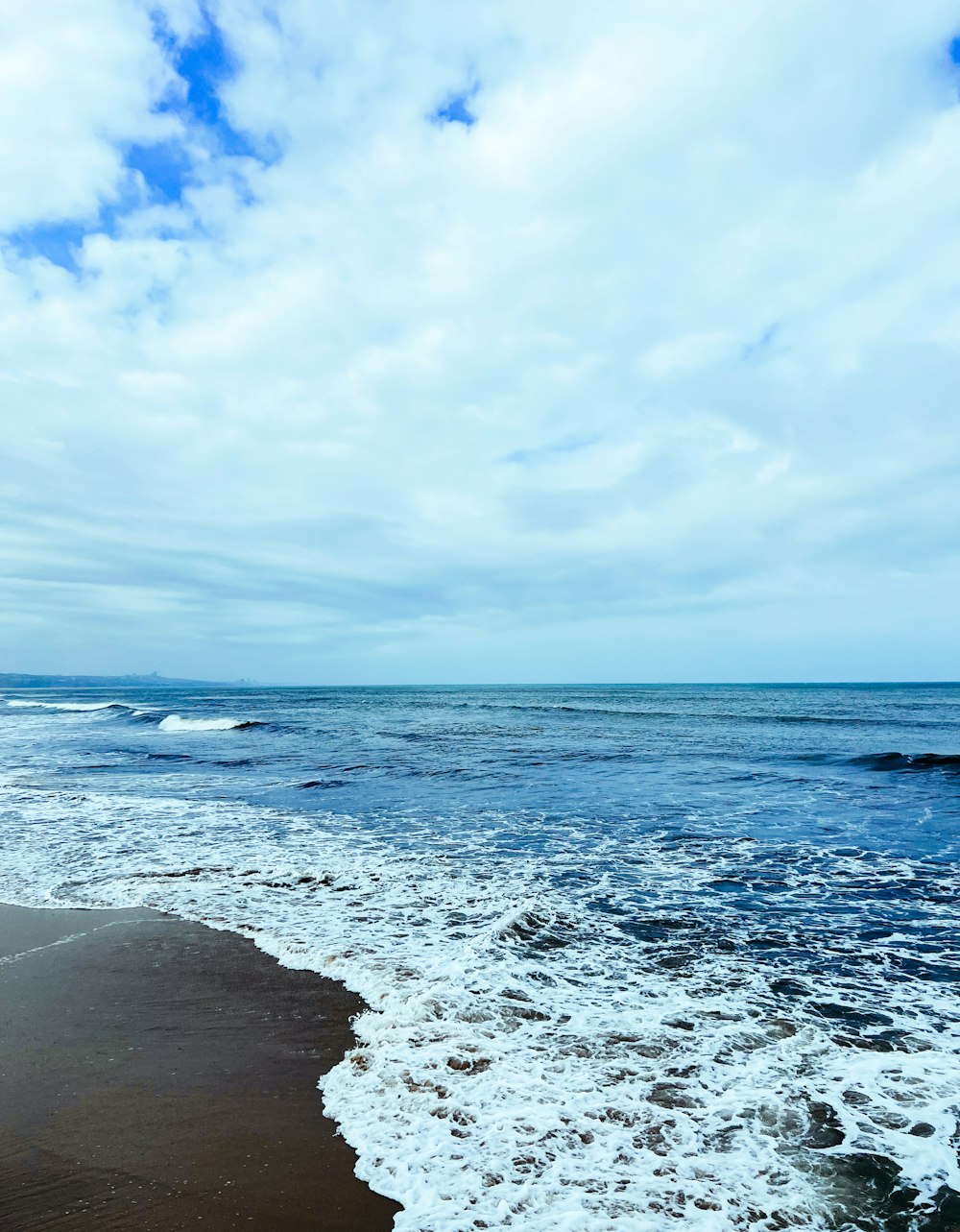 a beach with waves coming in to shore