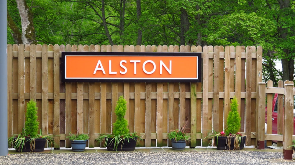 a wooden fence with a sign that says alston