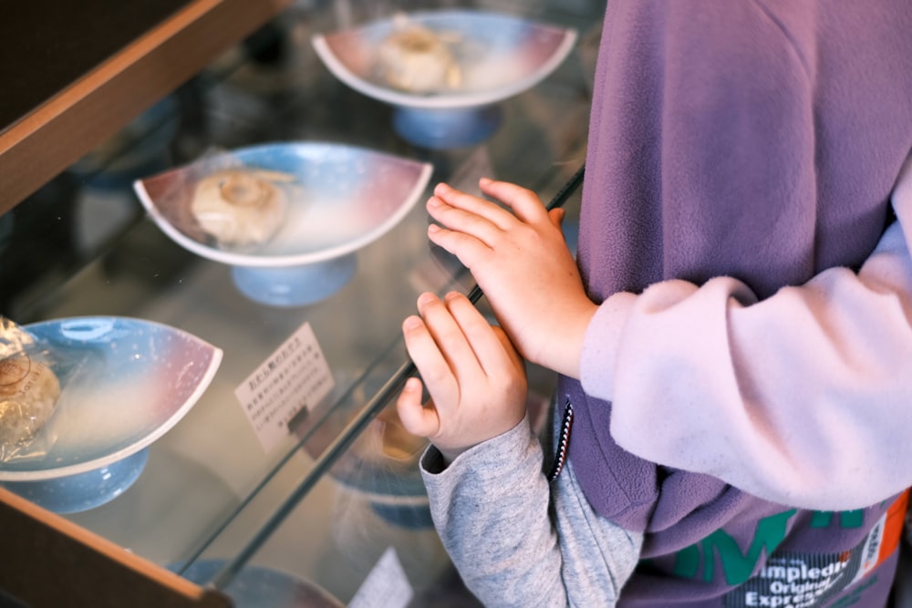 a person standing in front of a glass display case